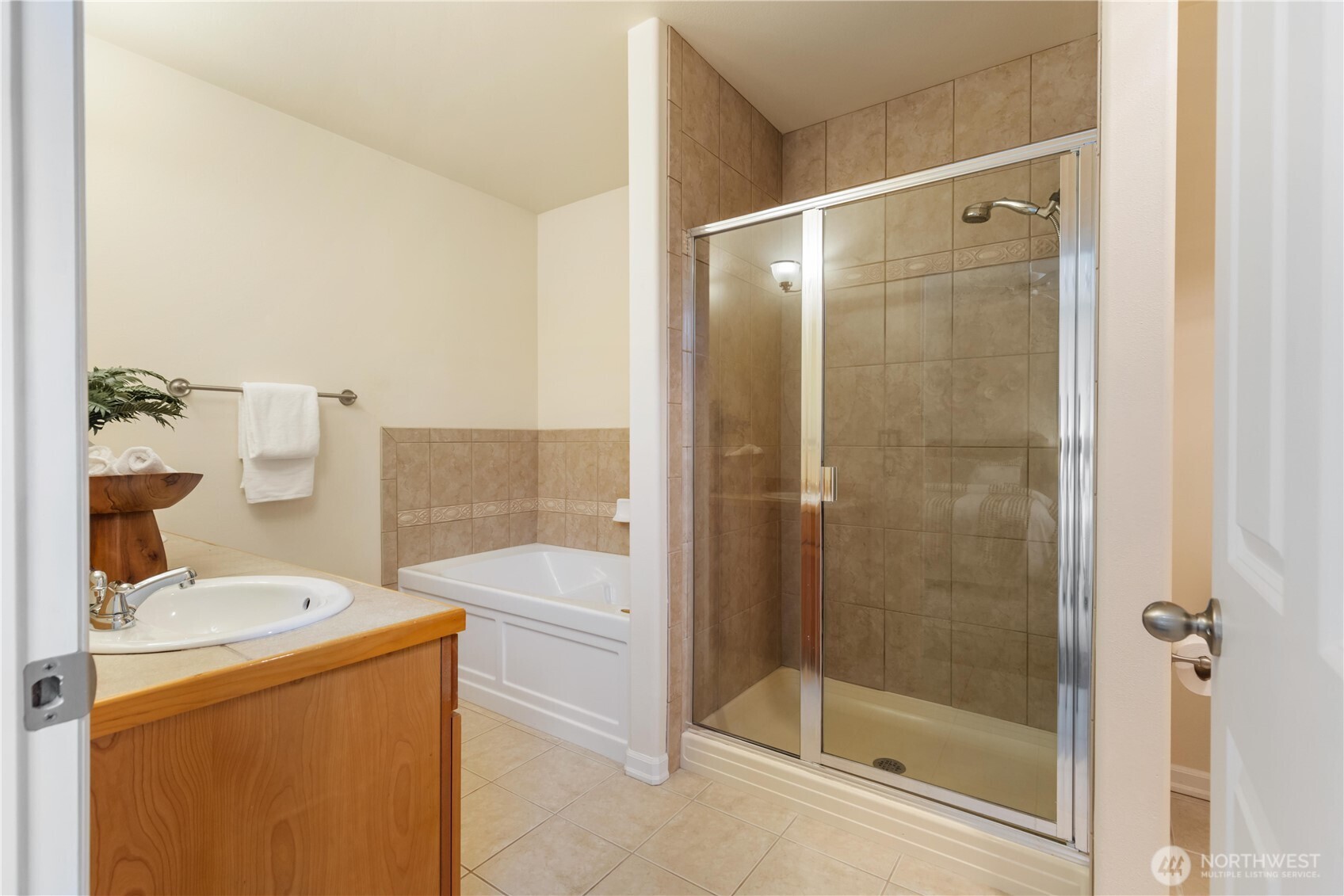 550 Dayton Street, Unit 201 Edmonds, WA 98020 - Photo 23 of 38 a bathroom with a shower a sink and a mirror