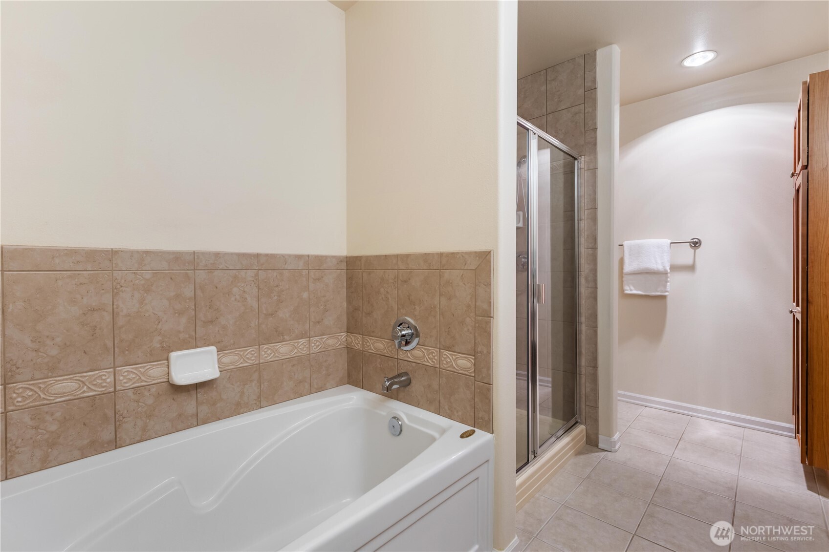 550 Dayton Street, Unit 201 Edmonds, WA 98020 - Photo 25 of 38 a bathroom with a bathtub and a shower