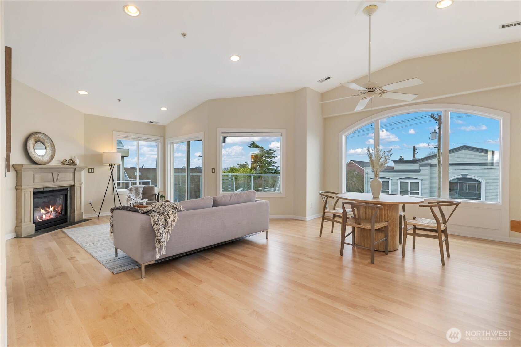 550 Dayton Street, Unit 201 Edmonds, WA 98020 - Photo 5 of 38 a living room with furniture a fireplace and a floor to ceiling window