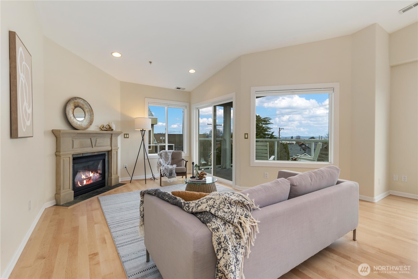 550 Dayton Street, Unit 201 Edmonds, WA 98020 - Photo 6 of 38 a living room with furniture a fireplace and a large window