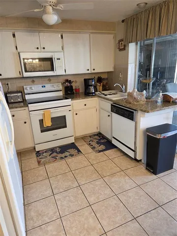 a kitchen with a stove a sink and a microwave