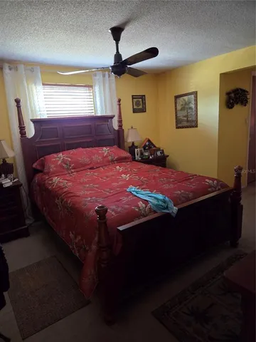 a bed sitting in a bedroom next to a window