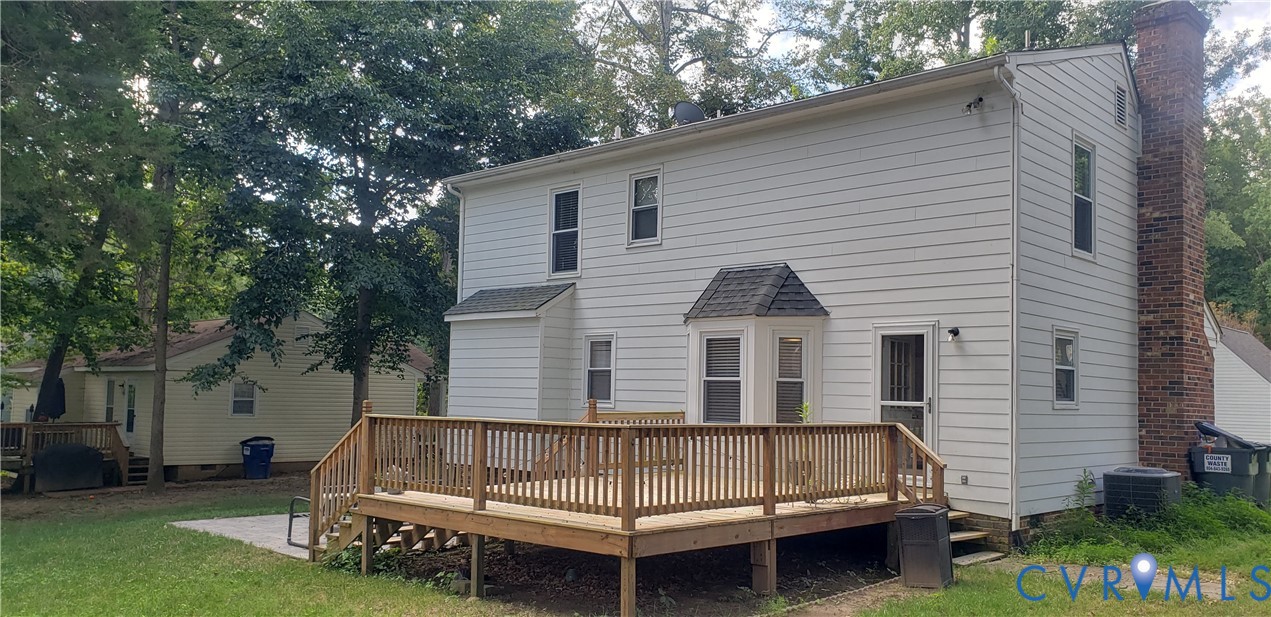 7166 Full Rack Drive Midlothian, VA 23112 - Photo 18 of 19 a view of backyard with a garden and deck