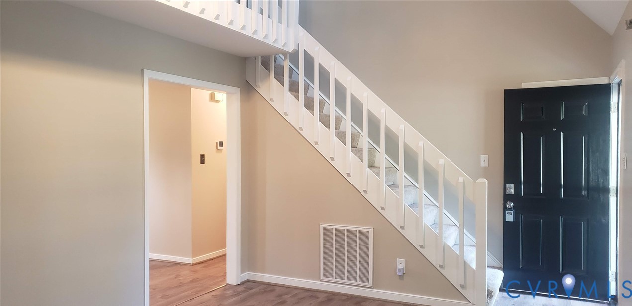 7166 Full Rack Drive Midlothian, VA 23112 - Photo 2 of 19 a view of staircase with wooden floor and staircase