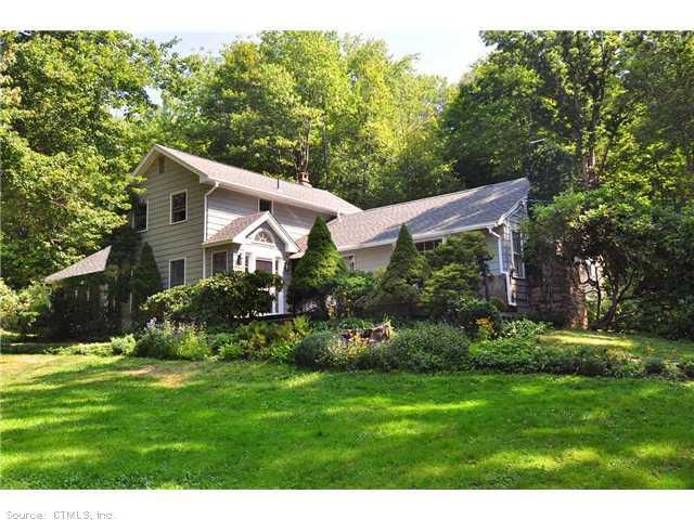 48 Morgan Road Canton, CT 06019 - Photo 1 of 1 a backyard of a house with plants and large trees
