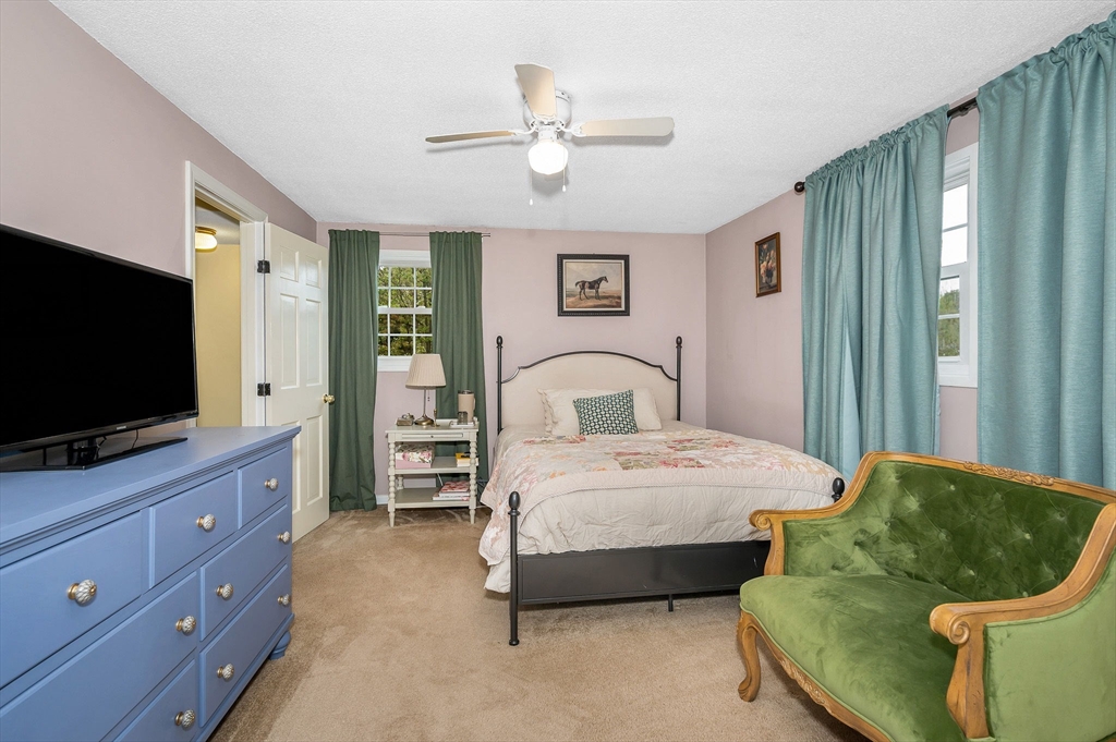 43 Constitution Way, Unit 43 Methuen, MA 01844 - Photo 13 of 25 a bedroom with a bed and a flat screen tv