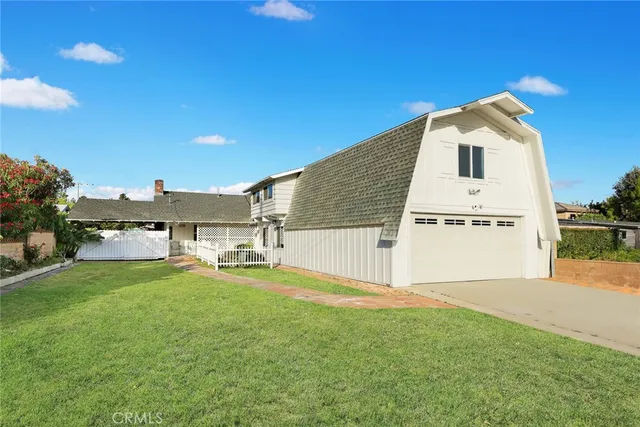 a view of a house with a yard and sitting area