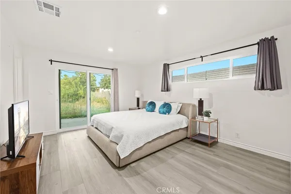 a bed room with a bed and a large window