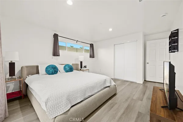 a bedroom with a bed and a flat screen tv