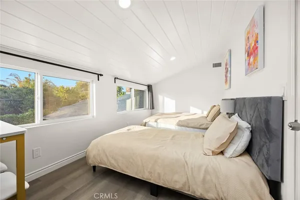 a bedroom with a large bed and a window