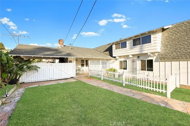 a view of a house with a yard and deck