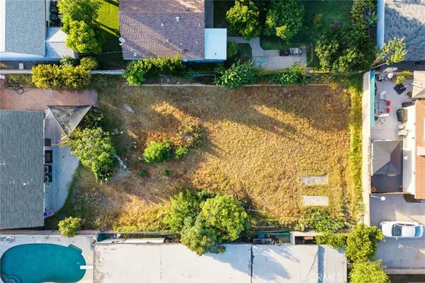 an aerial view of house with yard swimming pool and outdoor seating