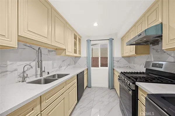 a kitchen that has a sink and a stove
