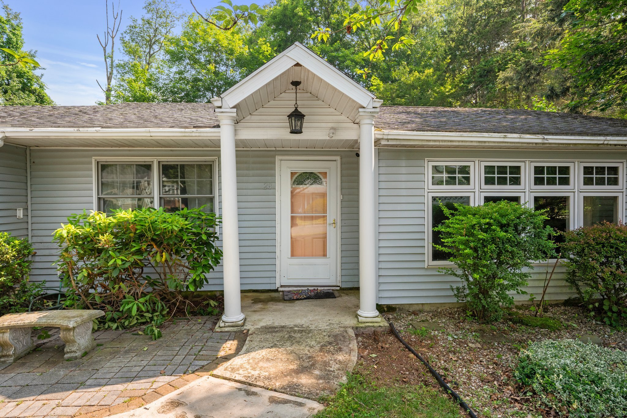 a view of a house with a yard and plants