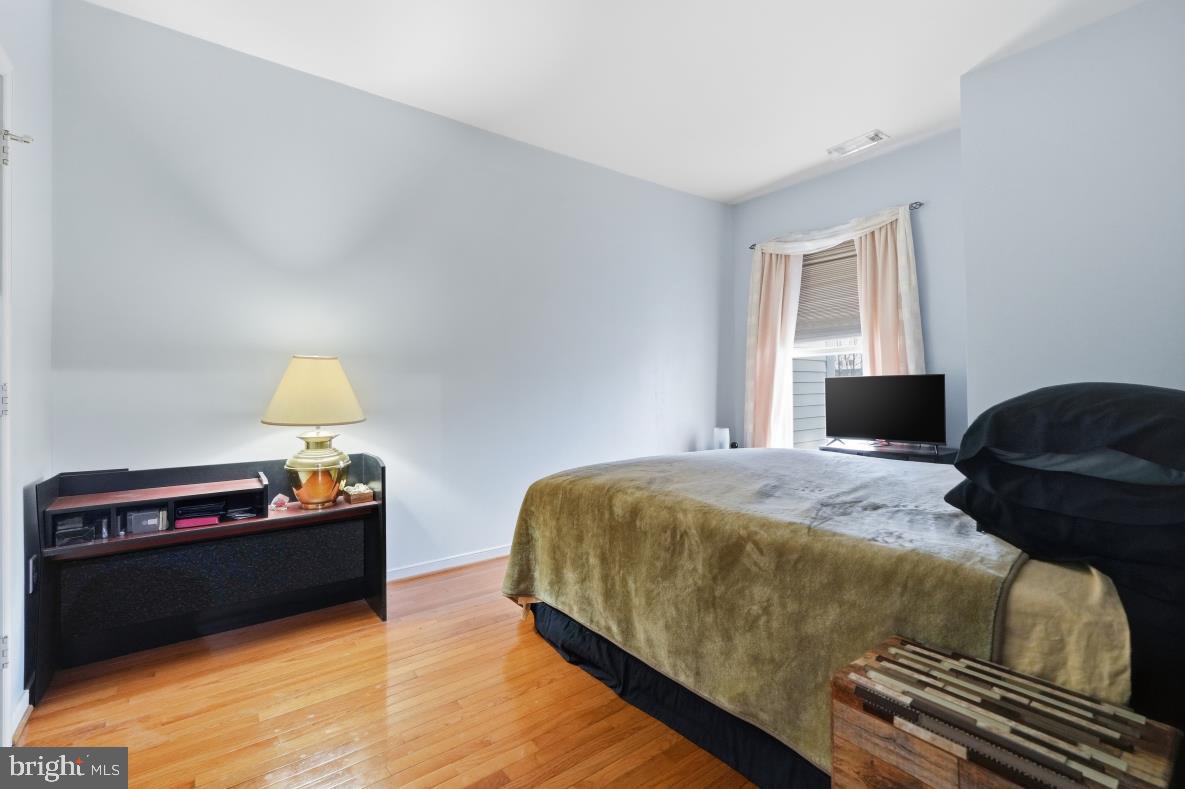 8045 Newell Street, Unit 423 Silver Spring, MD 20910 - Photo 11 of 26 a bedroom with a bed and window