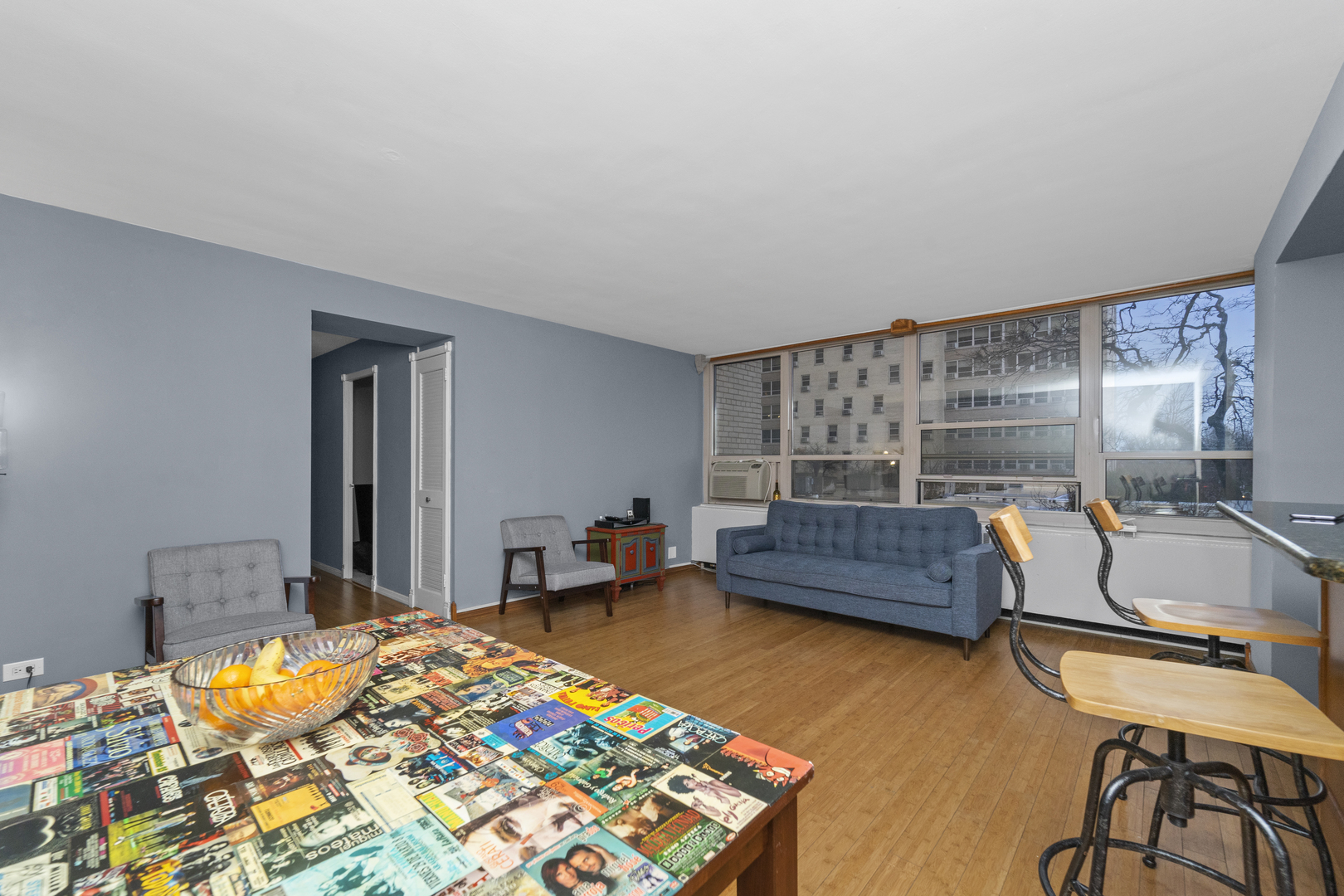 3950 North Lake Shore Drive, Unit 228 Chicago, IL 60613 - Photo 14 of 28 a bedroom with furniture and a wooden floor