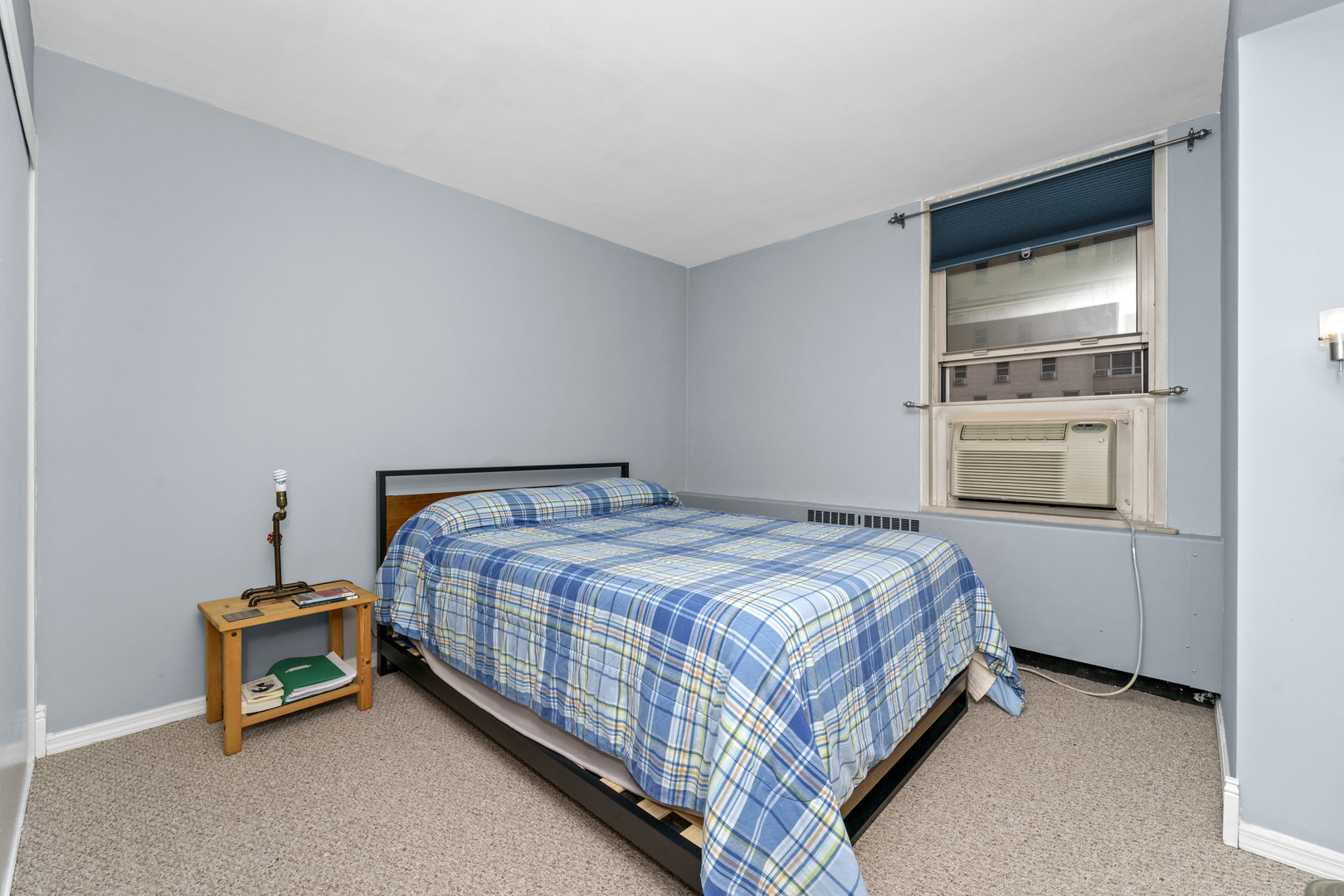 3950 North Lake Shore Drive, Unit 228 Chicago, IL 60613 - Photo 20 of 28 a bedroom with a bed and a window