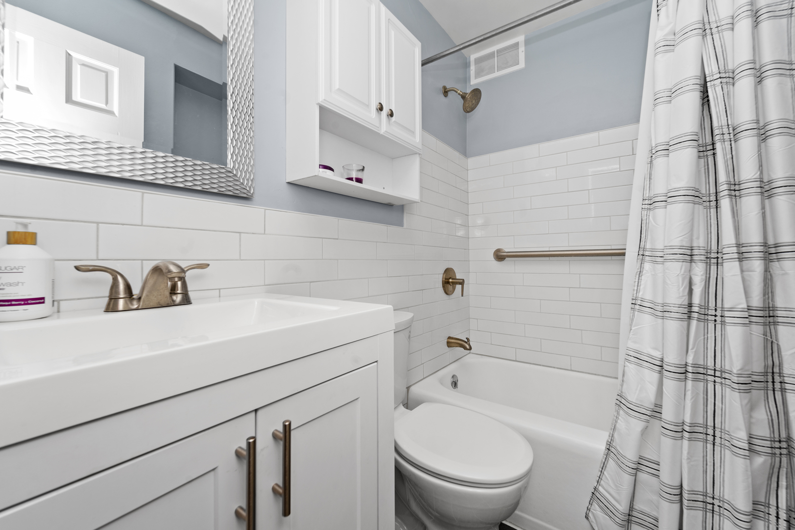 3950 North Lake Shore Drive, Unit 228 Chicago, IL 60613 - Photo 24 of 28 a bathroom with a sink a toilet and shower