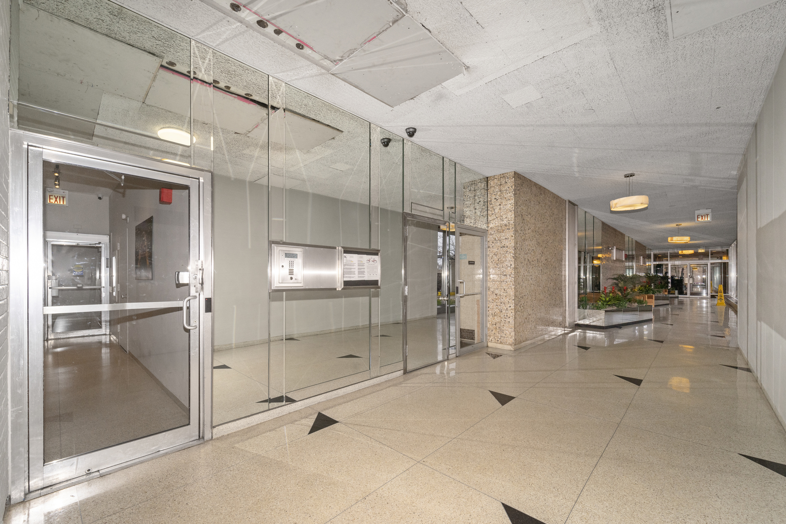 3950 North Lake Shore Drive, Unit 228 Chicago, IL 60613 - Photo 3 of 28 a lobby with furniture and a glass door shower