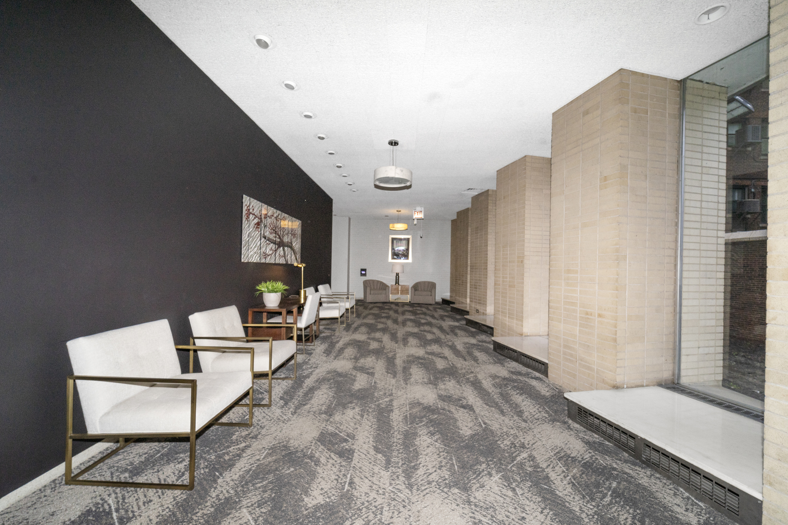3950 North Lake Shore Drive, Unit 228 Chicago, IL 60613 - Photo 6 of 28 a living room with furniture a rug and white walls