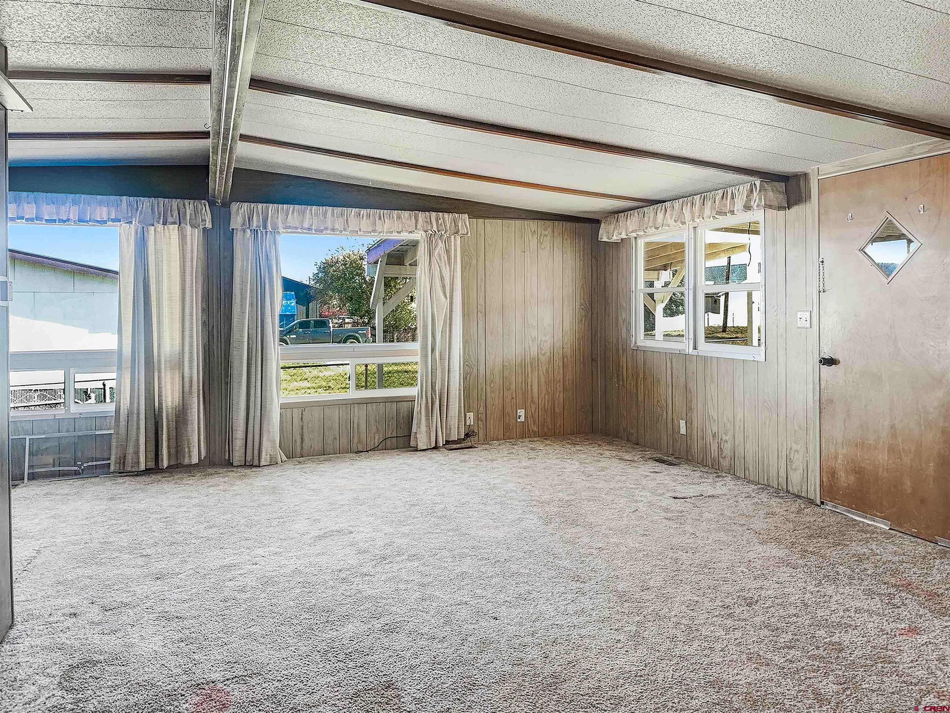 1318 Jackson Street Cortez, CO 81321 - Photo 4 of 13 an empty room with windows