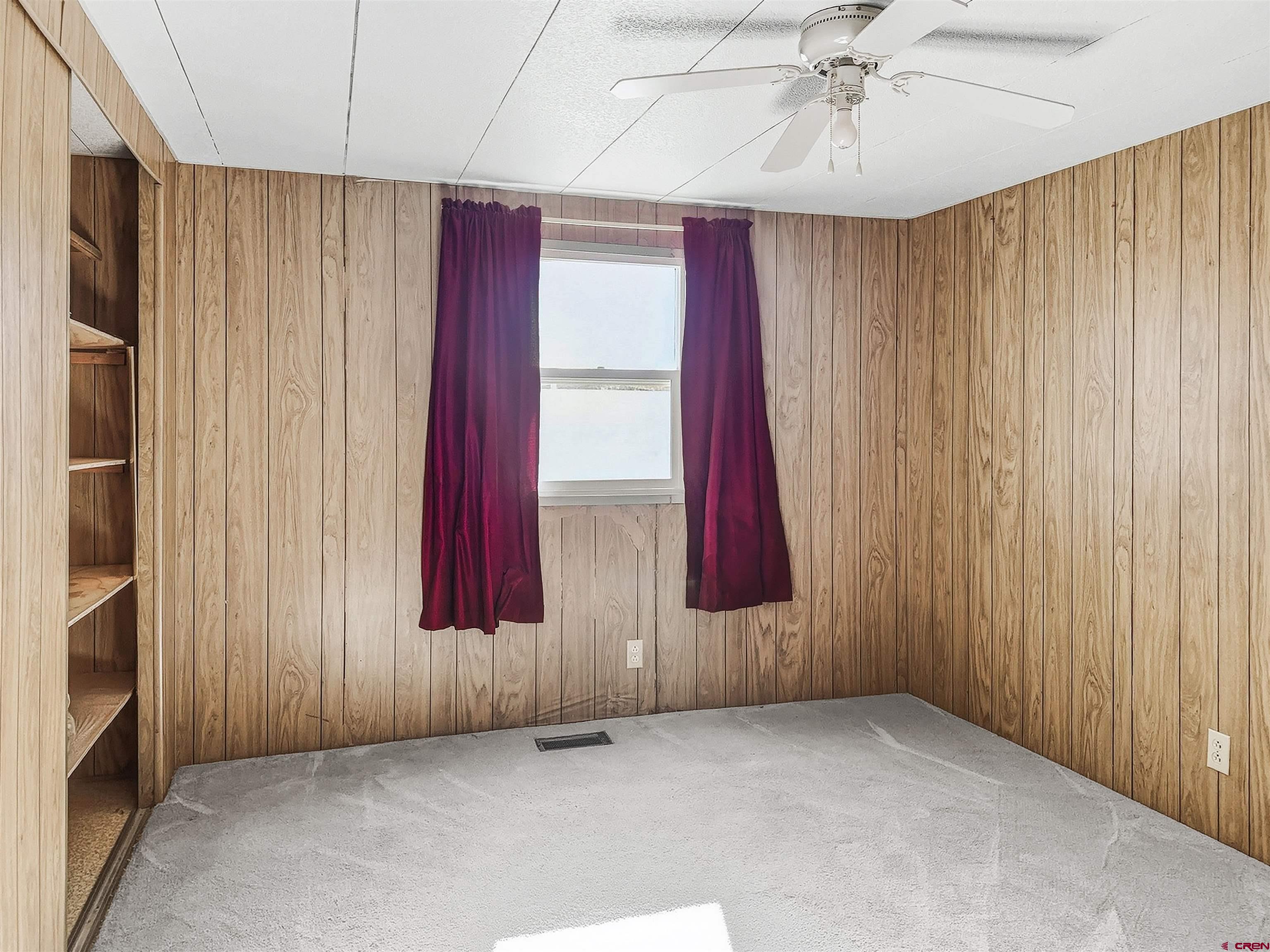 1318 Jackson Street Cortez, CO 81321 - Photo 7 of 13 an empty room with windows and closet