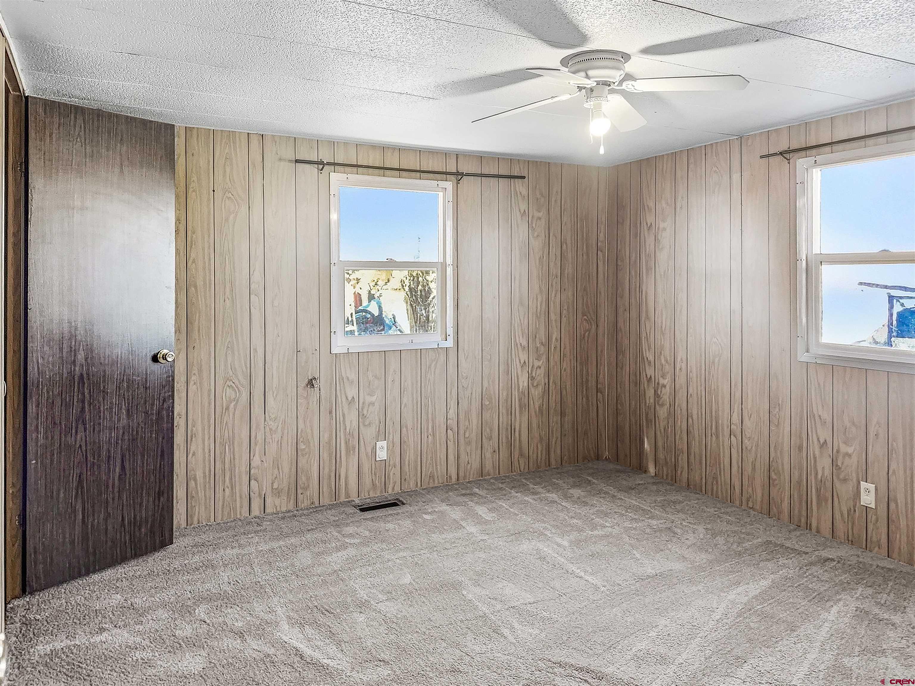 1318 Jackson Street Cortez, CO 81321 - Photo 10 of 13 an empty room with windows and fan