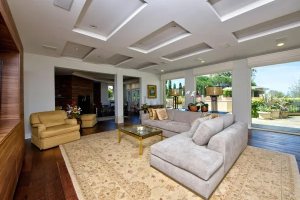 a living room with furniture wooden floor and a large window