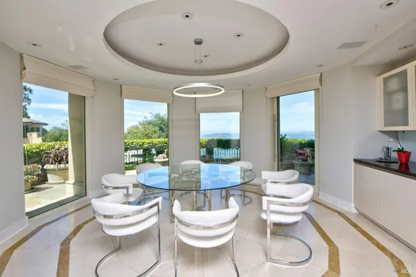 a living room with a white table and a large window