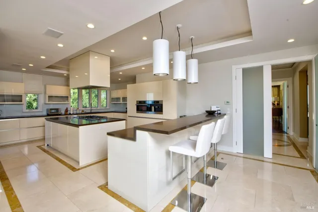 a kitchen with stainless steel appliances kitchen island granite countertop a sink and cabinets