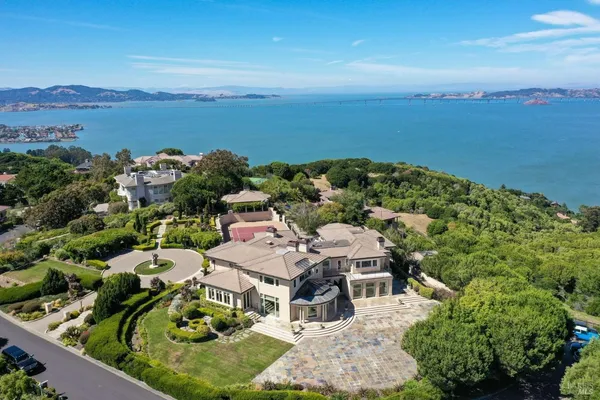 an aerial view of a house with garden space and ocean view