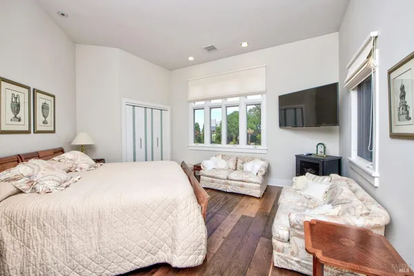 a bedroom with a bed and a flat screen tv