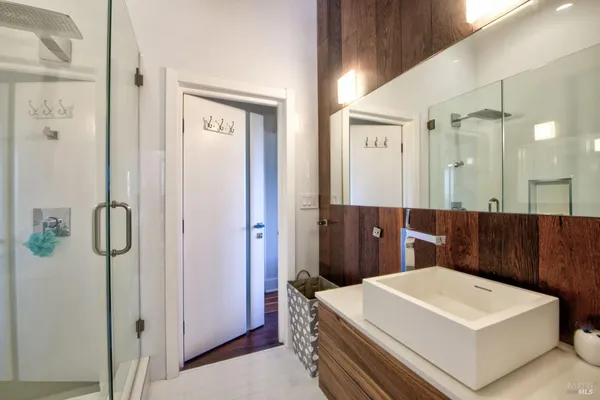 a bathroom with a sink a mirror and a shower