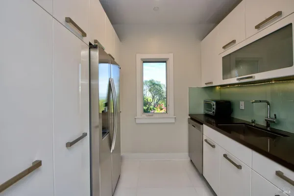 a bedroom with two beds and a large window