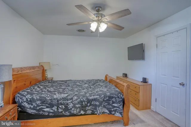 a bed sitting in a room next to a lamp