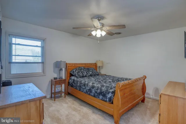 a bedroom with a bed and a desk in it