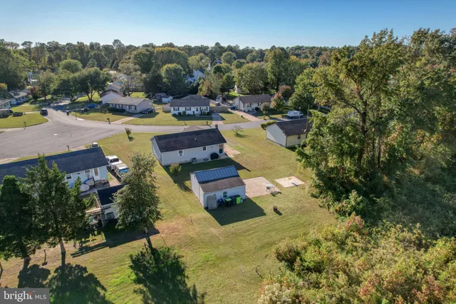 an aerial view of a house with swimming pool outdoor seating and yard