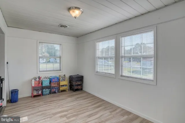 a view of a livingroom with furniture and a window
