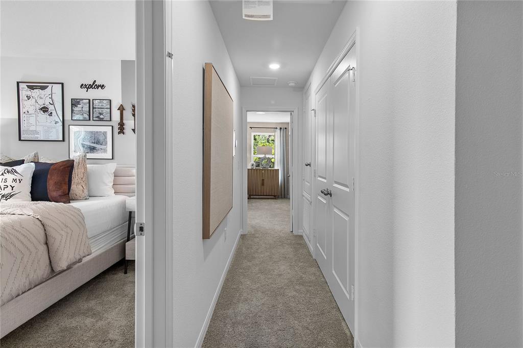 16639 Luminary Loop Clermont, FL 34714 - Photo 17 of 26 a view of a bedroom with bed and hallway