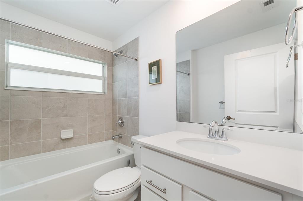 43992 Boardwalk Loop, Unit 1526 Punta Gorda, FL 33982 - Photo 16 of 48 a bathroom with a sink toilet a bathtub and shower