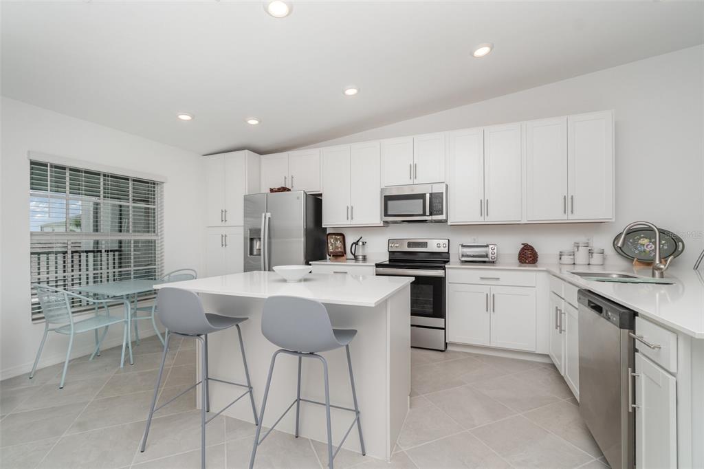 43992 Boardwalk Loop, Unit 1526 Punta Gorda, FL 33982 - Photo 6 of 48 a kitchen with a sink stainless steel appliances and white cabinets