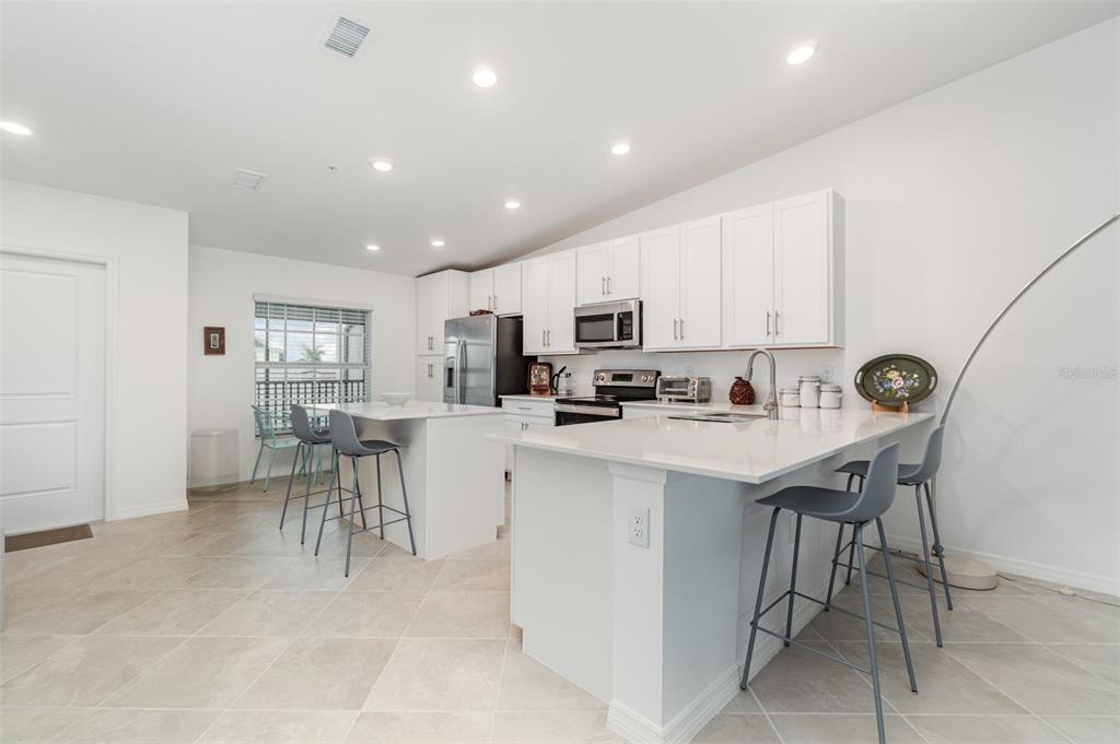 43992 Boardwalk Loop, Unit 1526 Punta Gorda, FL 33982 - Photo 7 of 48 a view of kitchen with cabinets table and chairs