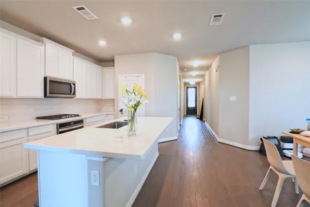 a kitchen with appliances a sink and a counter top space