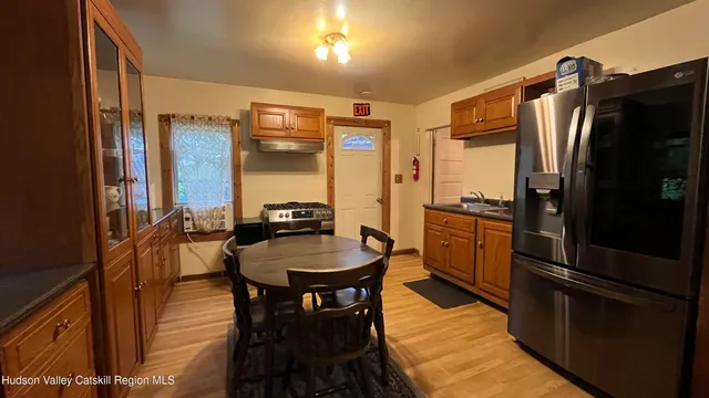 a kitchen with refrigerator and sink