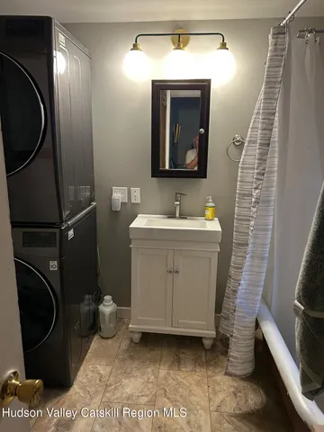 a bathroom with a sink a toilet and mirror