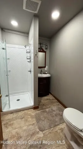 a bathroom with a toilet and a shower