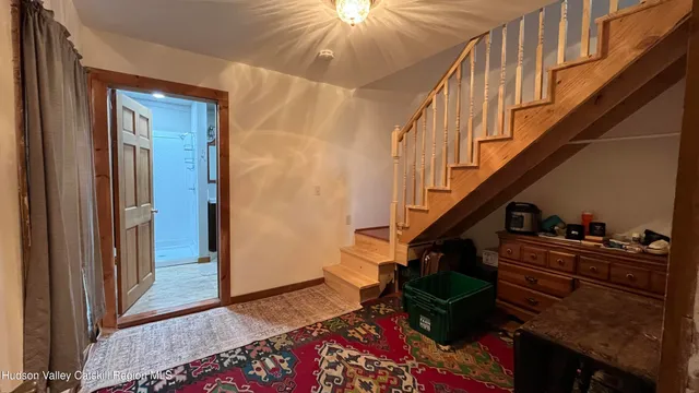 a view of entryway and hall with wooden floor