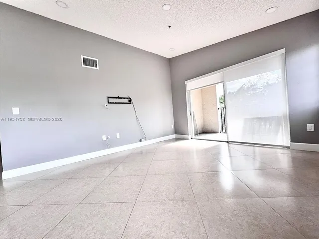 a view of an empty room with glass door