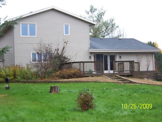 7663 East Rockton Road Roscoe, IL 61073 - Photo 3 of 10 a front view of a house with a yard and green space