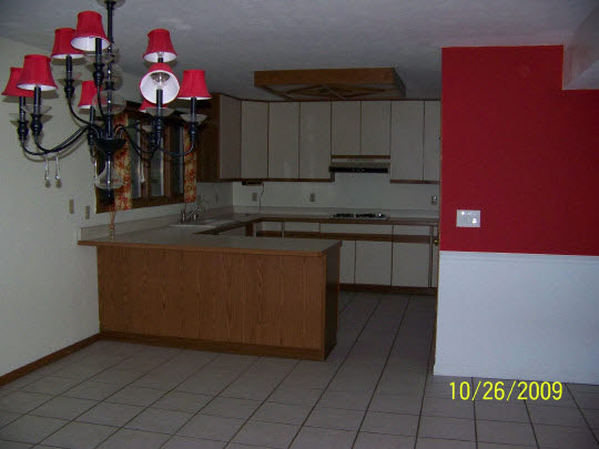 7663 East Rockton Road Roscoe, IL 61073 - Photo 4 of 10 a kitchen with granite countertop a sink a stove and cabinets